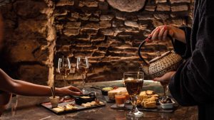 Elegant mint tea service accompanied by regional products and glasses of wine, in a refined and exclusive setting